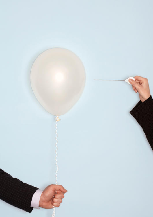 Pessimistic woman bursting gift of a balloon
